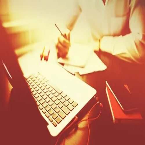 A stack of books and a laptop, representing the wealth of resources available for bloggers to enhance their content creation skills and knowledge. prompt